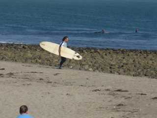 Malibu surfer on Zuma Beach near sunset